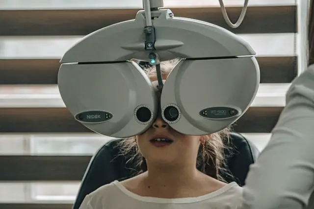 Young girl undergoing an eye exam at an optometrist’s office