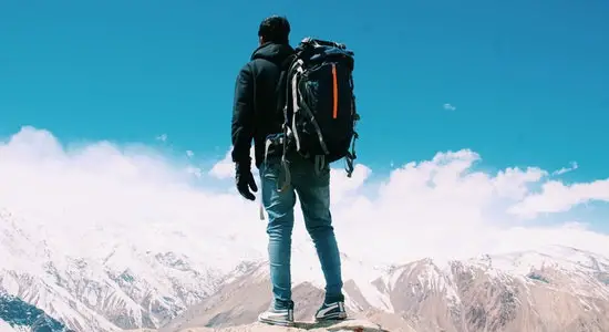 Traveller at the top of snow clad mountains