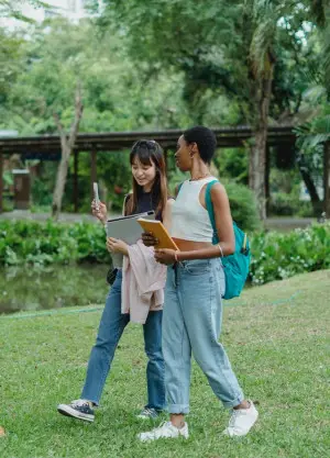 Two female college students strolling through campus.