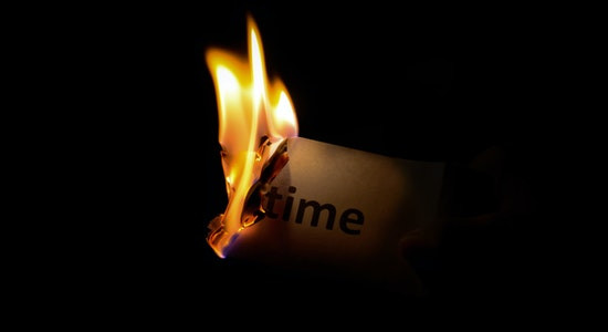 Burning paper with the word time written on it