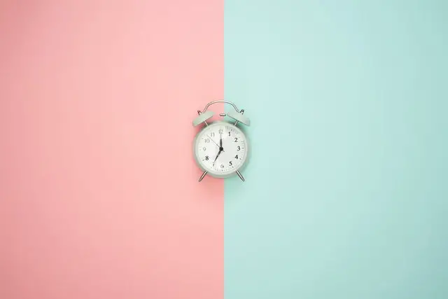 Photo of a clock against a two-toned background