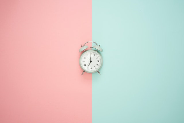 Photo of a clock against a two-toned background