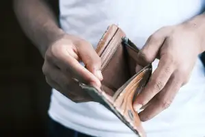 A photo of a student with an empty wallet